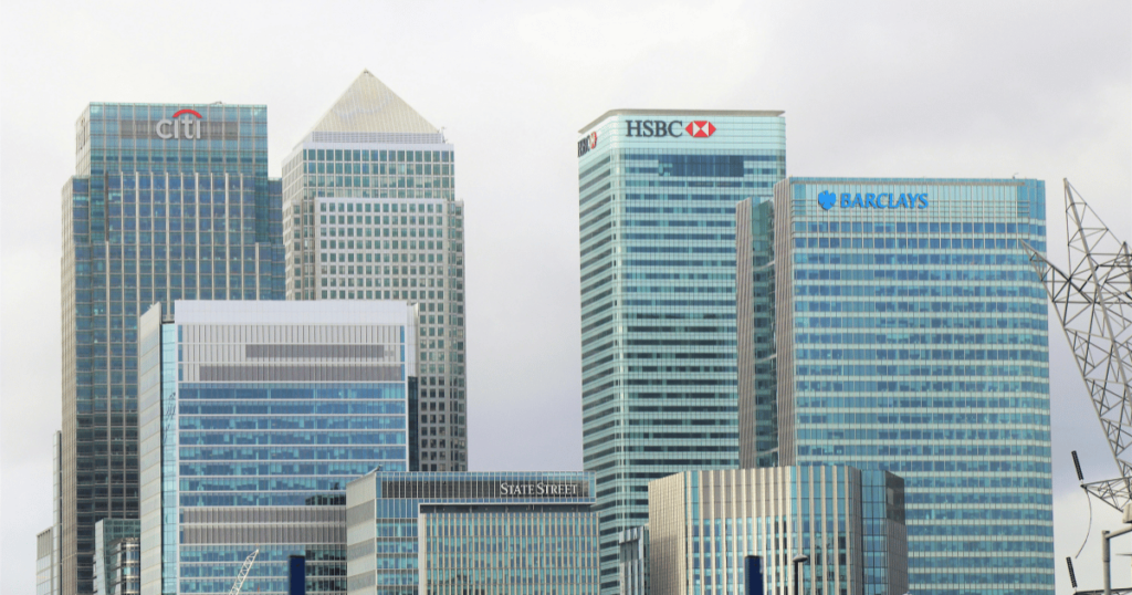 A picture of a city skyline featuring major banking institutions. Banks will be major beneficiaries to interest rate cuts.